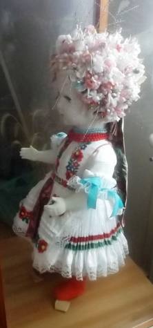 D�szes ruh�kba �lt�ztetett baba.